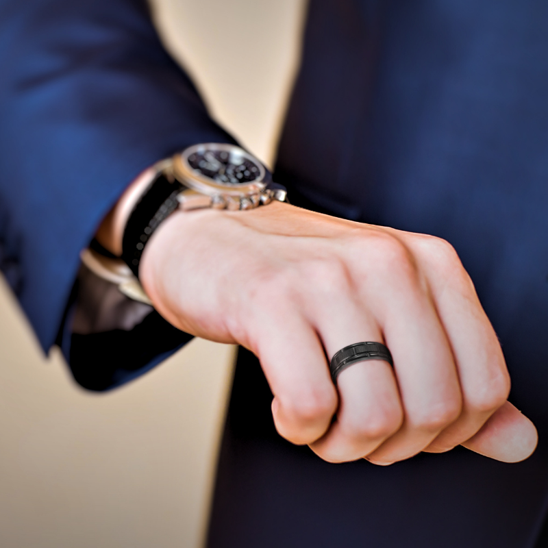 black tungsten ring on mans finger